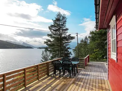 a deck with chairs and a view of the water at Holiday Home Rød Hytte by Interhome in Herand