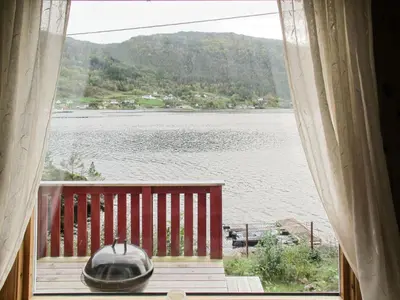 a window with a view of a lake from a house at Holiday Home Rød Hytte by Interhome in Herand