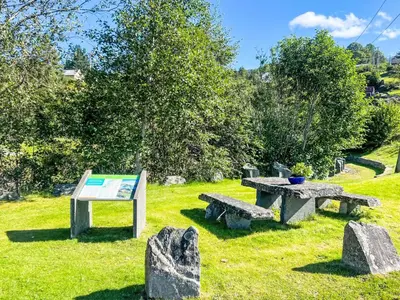 a park with benches and a table and a sign at Holiday Home Rød Hytte by Interhome in Herand