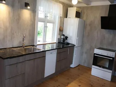 a kitchen with a white refrigerator and a sink at Holiday Home Ikjefjord by Interhome in Bjordal
