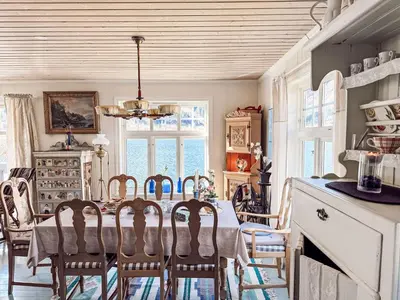 a kitchen and dining room with a table and chairs at Chalet Villa Esefjord by Interhome in Balestrand