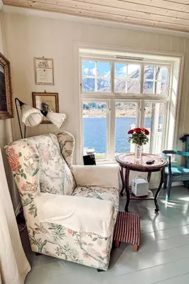a living room with a chair and a table and a window at Chalet Villa Esefjord by Interhome in Balestrand