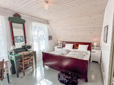 a bedroom with a large bed and a desk at Chalet Villa Esefjord by Interhome in Balestrand