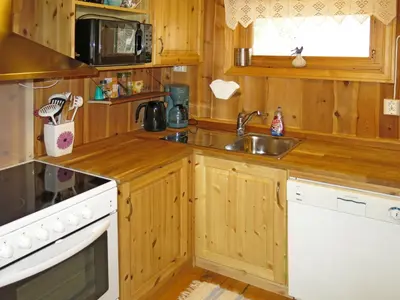 a kitchen with wooden cabinets and a sink at Chalet Målsnes by Interhome in Balestrand