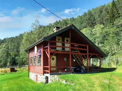 a small red house with a dog on the roof at Chalet Målsnes by Interhome in Balestrand