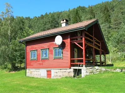 a red cabin in the middle of a field at Chalet Målsnes by Interhome in Balestrand