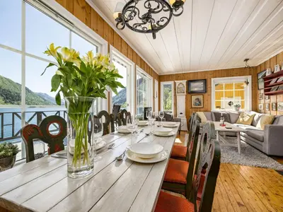 a dining room with a long wooden table and chairs at Holiday Home Eseviki by Interhome in Balestrand