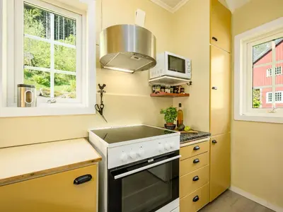 a kitchen with a stove and a microwave at Holiday Home Eseviki by Interhome in Balestrand