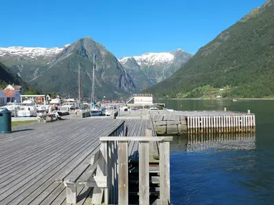 a dock on a lake with mountains in the background at Chalet Naustet by Interhome in Balestrand