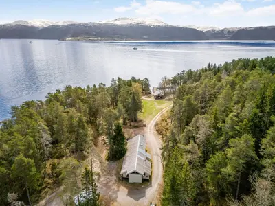 an aerial view of a house on the shore of a lake at Holiday Home Veganeset I by Interhome in Balestrand