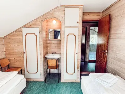 a bathroom with two beds and a sink in a room at Holiday Home Tantestova by Interhome in Balestrand