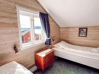 two beds in a room with a window at Holiday Home Tantestova by Interhome in Balestrand