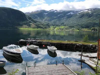 two boats are docked at a dock on a lake at Holiday Home Nausthammar by Interhome in Davik