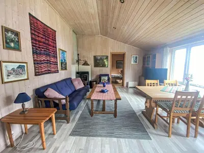 a living room with a blue couch and a table at Holiday Home Nausthammar by Interhome in Davik