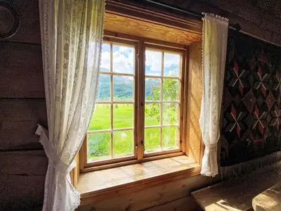 a window in a room with a view of a field at Chalet Haukedalspanorama by Interhome in Holsen