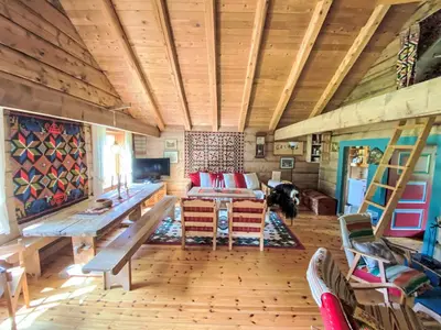 a living room with a table and a couch at Chalet Haukedalspanorama by Interhome in Holsen