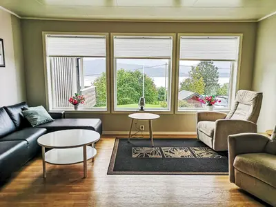 a living room with a couch and a table at Apartment Mjellhaugen by Interhome in Naustdal i Sunnfjord