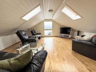 a living room with skylights and black leather furniture at Holiday Home Rorbu by Interhome in Naustdal i Sunnfjord