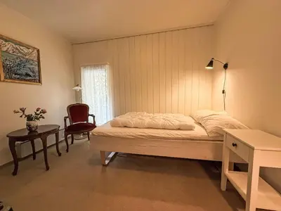 a bedroom with a bed and a table and a chair at Holiday Home Kvamsvika by Interhome in Kvammen