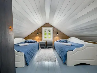 two beds in a room with a attic at Holiday Home Johans Maria stova by Interhome in Arnefjord