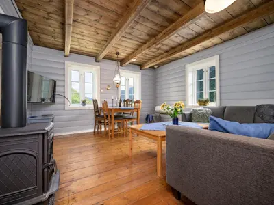 a living room with a couch and a wood stove at Holiday Home Johans Maria stova by Interhome in Arnefjord
