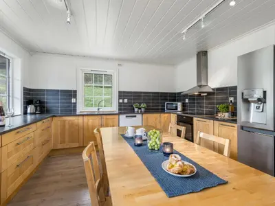 a kitchen with a table with a bowl of fruit on it at Holiday Home Odin by Interhome in Arnefjord