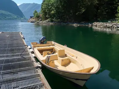 a boat is tied to a dock on the water at Holiday Home Jambueggi by Interhome in Arnefjord