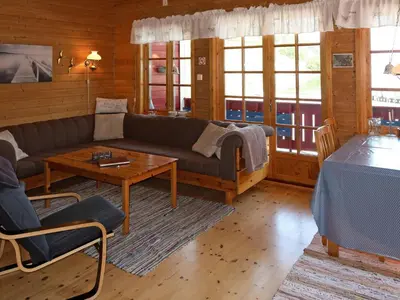 a living room with a couch and a table at Holiday Home Jambueggi by Interhome in Arnefjord