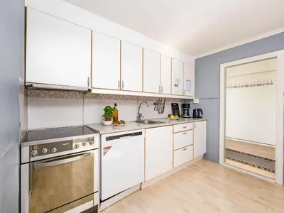 a kitchen with white cabinets and a sink at Holiday Home Indresfjord by Interhome in Åse