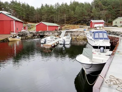 a group of boats are docked in a harbor at Holiday Home Solsvika by Interhome in Leirvik