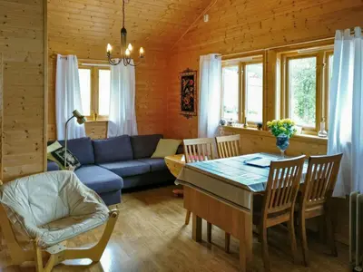 a living room with a blue couch and a table at Holiday Home Idun by Interhome in Hyllestad