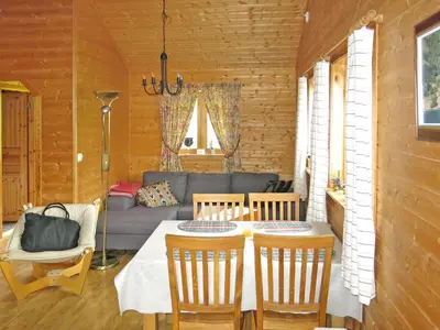 a living room with a table and a couch at Holiday Home Idun by Interhome in Hyllestad