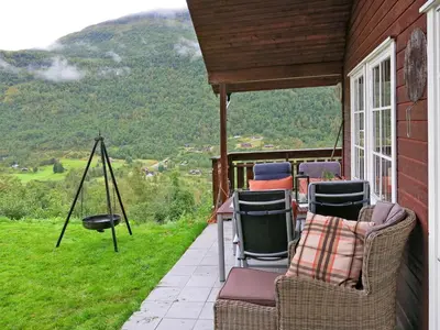 a porch with chairs and a view of a mountain at Holiday Home Peer Gynt by Interhome in Sogndal