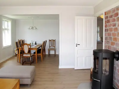a kitchen and dining room with a table and chairs at Holiday Home Strøneneset by Interhome in Hagavik