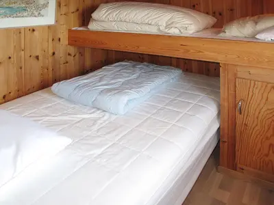 two bunk beds in a wooden cabin at Holiday Home Hjartnesvika by Interhome in Hjartåker
