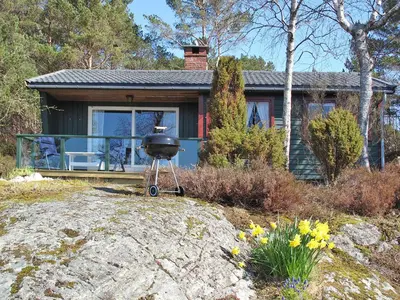 a grill sitting in front of a house at Holiday Home Hjartnesvika by Interhome in Hjartåker
