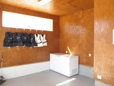a waiting room with black chairs and a window at Apartment Gurevika by Interhome in Nordhuglo