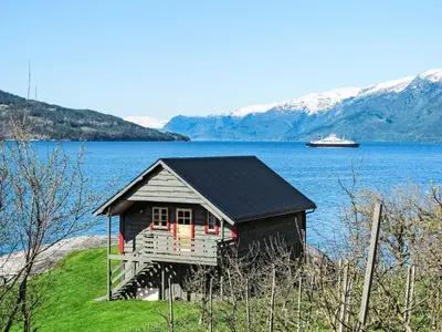 a small house on the shore of a body of water at Chalet Hardangerrorbu by Interhome in Tjoflot
