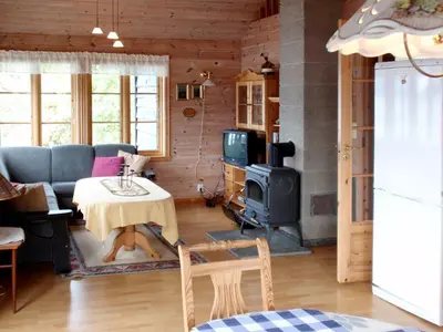 a living room with a couch and a stove at Chalet Eiknes by Interhome in Tjoflot