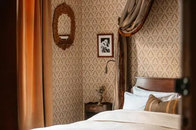 a bedroom with a bed and a wall at Hotel Union Øye in Øye