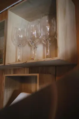 a group of wine glasses sitting on a shelf at Valsøya in Valsøyfjord
