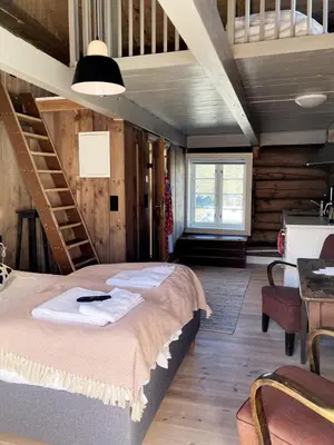 a bedroom with a large bed and a staircase at Valsøya in Valsøyfjord