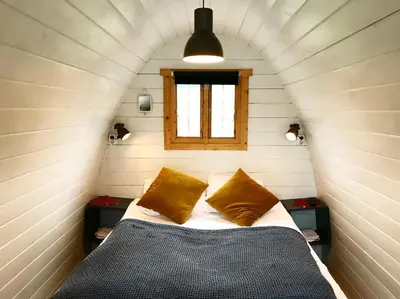 a bed in a small room with a window at Valsøya in Valsøyfjord