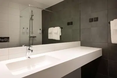 a bathroom with a white sink and a mirror at Scandic Voss in Vossevangen