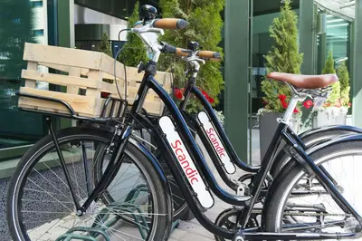 a black bike parked next to a bench at Scandic Voss in Vossevangen