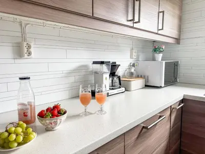a kitchen counter with two wine glasses and a bowl of fruit at Holiday Home Rødehuset by Interhome in Gjelland