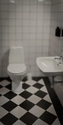 a bathroom with a white toilet and a sink at Hotell Molde in Molde
