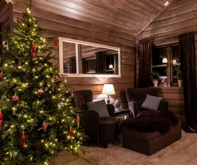 a living room with a christmas tree in a room at Cabin in Hodlekve with 5 bedrooms & hot tub. in Sogndal
