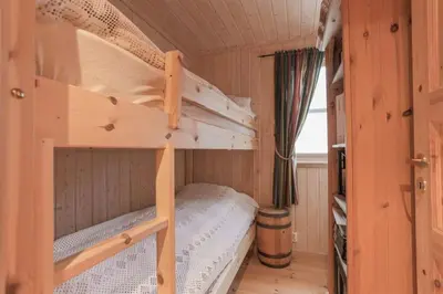 a bedroom with two bunk beds in a cabin at Cabin in Hodlekve with 5 bedrooms & hot tub. in Sogndal
