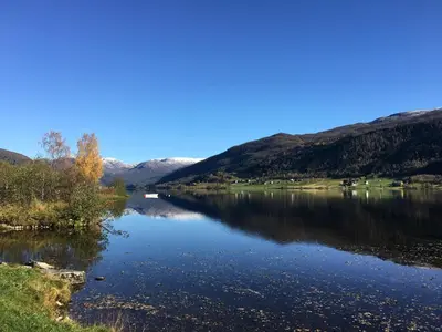 a view of a river with mountains in the background at Voss- Oppheim suite private cozy cabin in Vossestrand